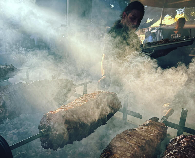 Pete the Greek cooking over a BBQ
